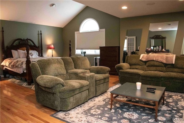 living room featuring hardwood / wood-style flooring and vaulted ceiling