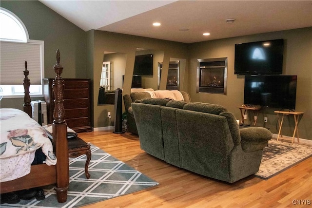 living room with vaulted ceiling and hardwood / wood-style floors