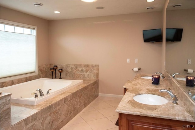 bathroom with tile patterned floors, a wealth of natural light, vanity, and tiled tub