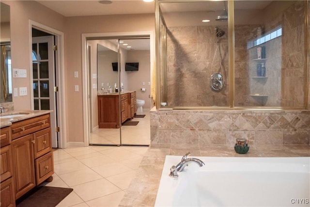 full bathroom featuring vanity, tile patterned floors, toilet, and separate shower and tub