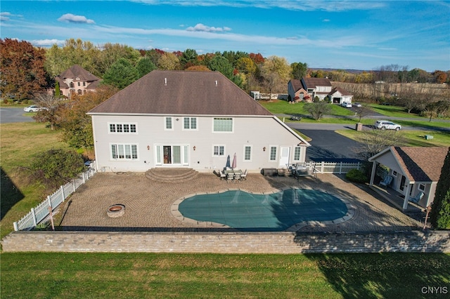 exterior space with french doors, a patio, a yard, and a fire pit