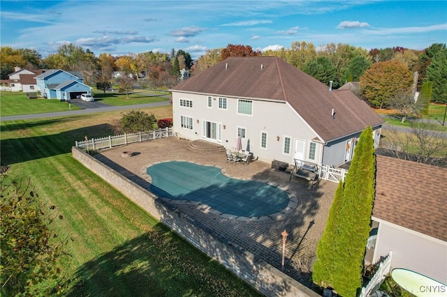 back of house with a yard and a patio area