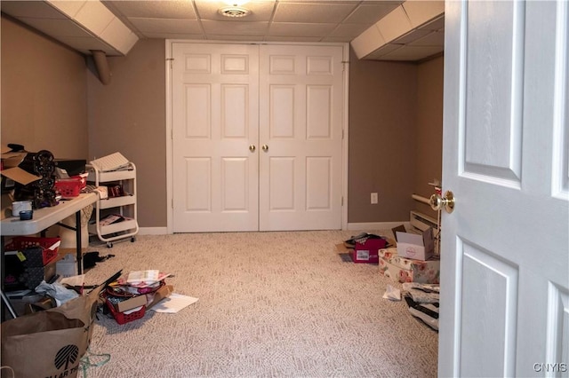 game room with a drop ceiling and carpet flooring