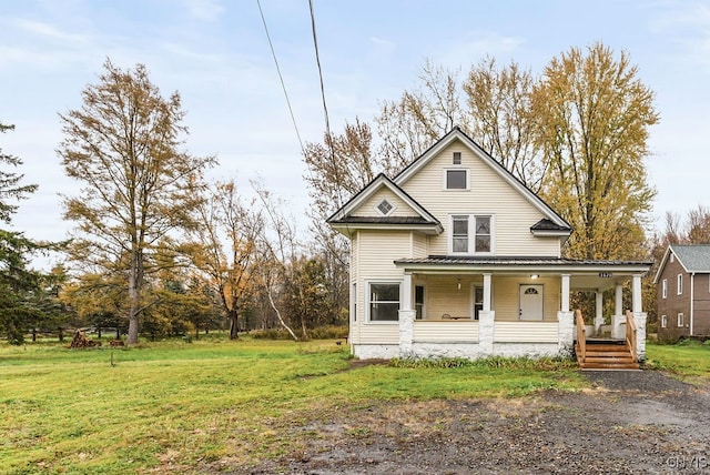 view of front of house with a front yard and a porch