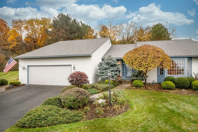 ranch-style home featuring a front lawn and a garage