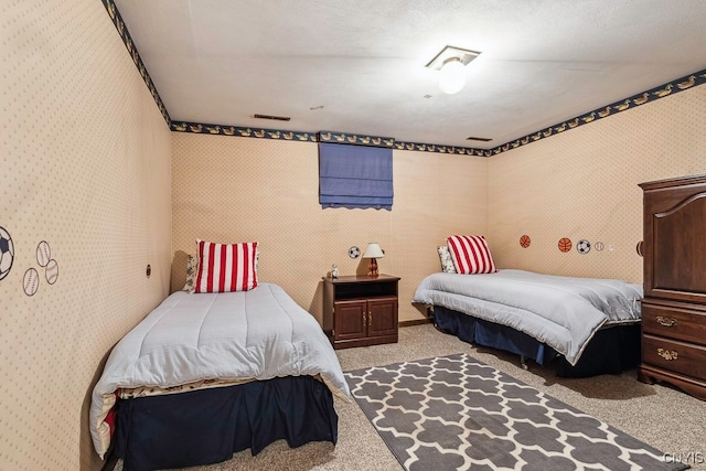 bedroom with light carpet and a textured ceiling