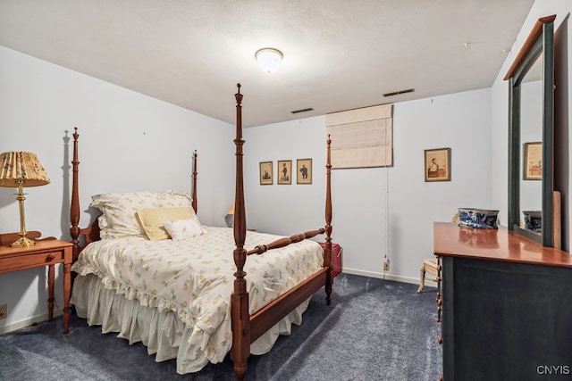 bedroom with dark colored carpet