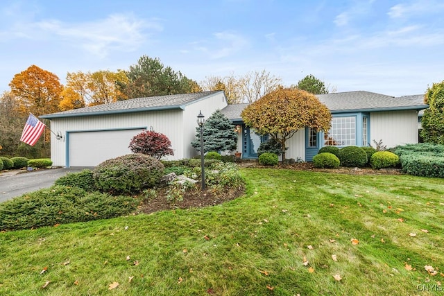 single story home with a front lawn and a garage