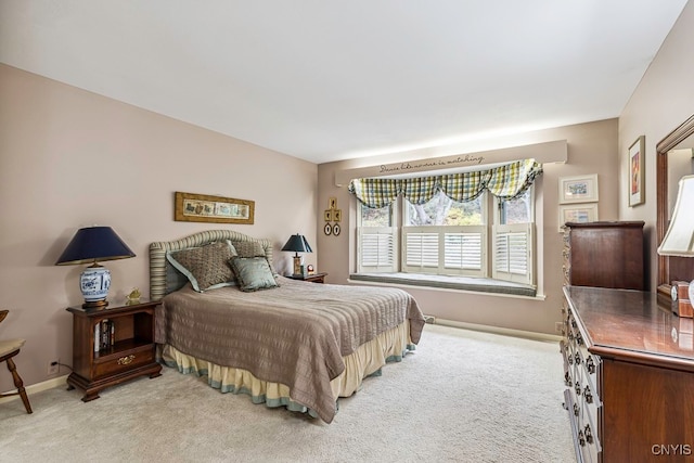 bedroom featuring light carpet