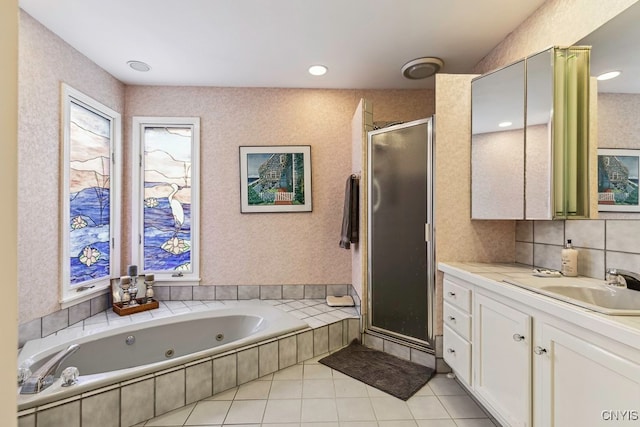 bathroom featuring vanity, independent shower and bath, and tile patterned flooring