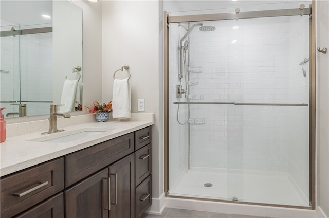 bathroom featuring vanity, tile patterned flooring, and a shower with door