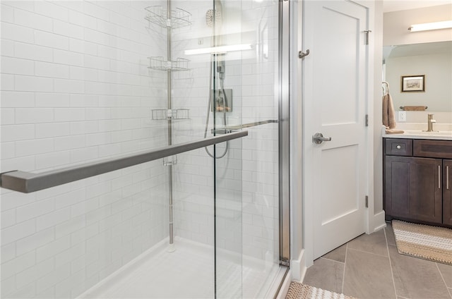 bathroom with vanity, tile patterned floors, and a shower with door