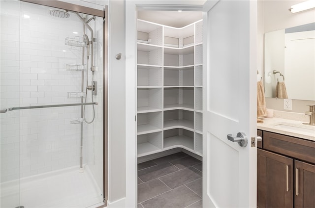 bathroom featuring vanity, walk in shower, and tile patterned flooring