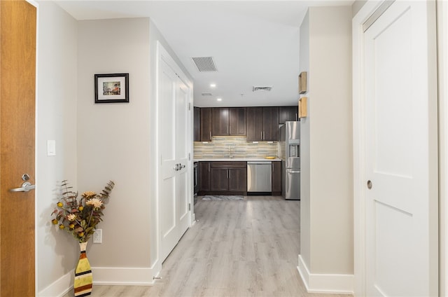 hall featuring sink and light hardwood / wood-style floors