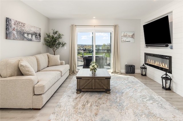 living room featuring light hardwood / wood-style flooring and a fireplace