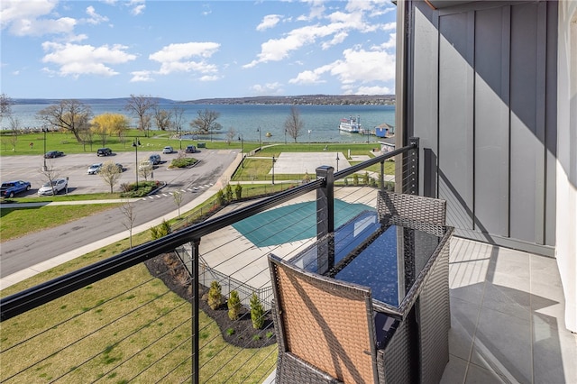 balcony featuring a water view