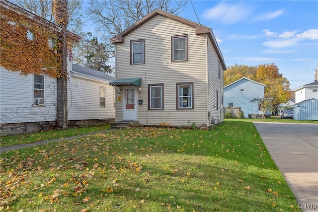 traditional-style house featuring a front lawn