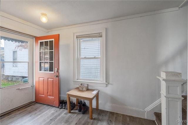 doorway featuring stairway, light wood-type flooring, and baseboards