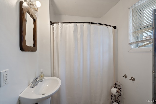 bathroom with a shower with curtain and sink