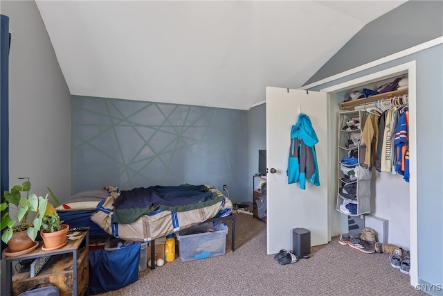 carpeted bedroom featuring lofted ceiling and a closet