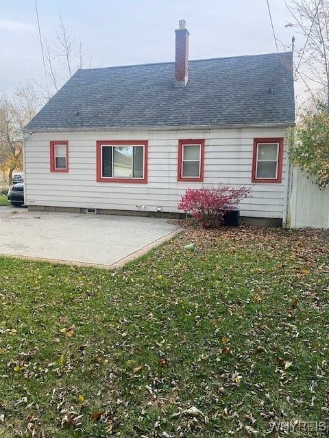 rear view of property featuring a yard and a patio