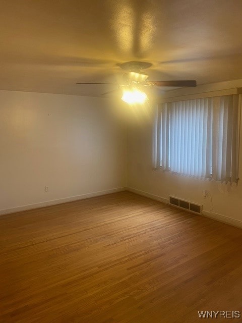 spare room featuring ceiling fan and hardwood / wood-style flooring