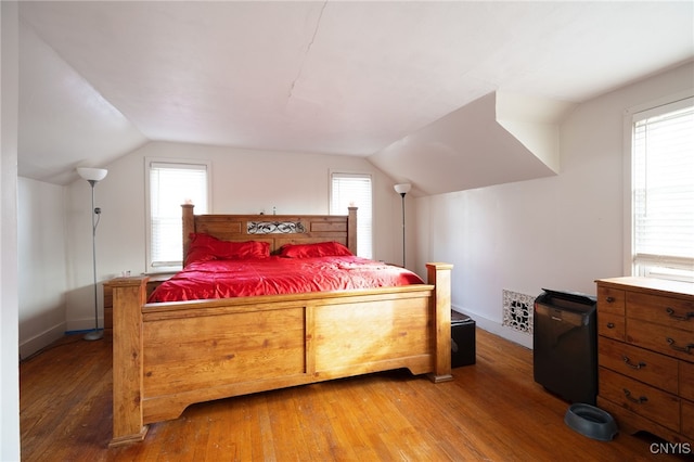 bedroom with hardwood / wood-style floors and vaulted ceiling