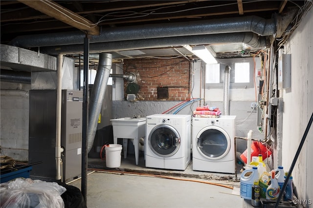 basement with independent washer and dryer, heating unit, and sink