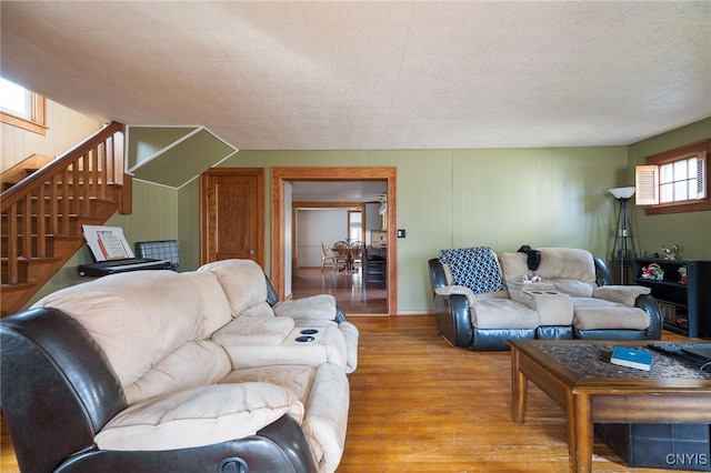 living room with a textured ceiling and wood-type flooring