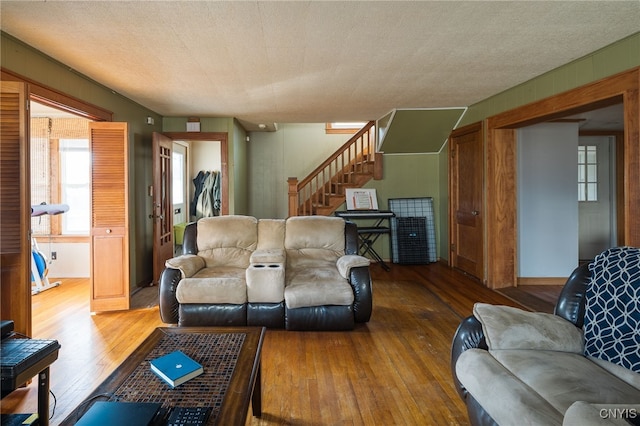 living room with a textured ceiling and hardwood / wood-style flooring