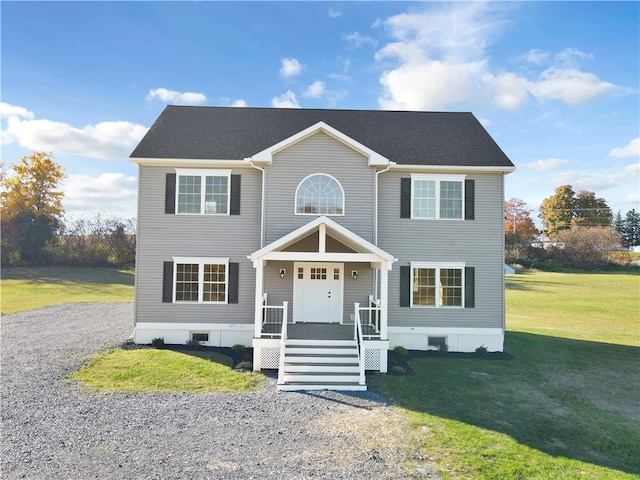 colonial-style house featuring a front yard and covered porch