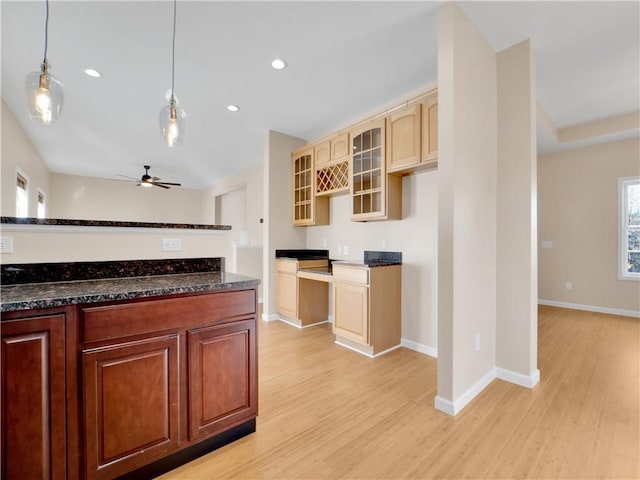 kitchen with hanging light fixtures, ceiling fan, and light hardwood / wood-style flooring