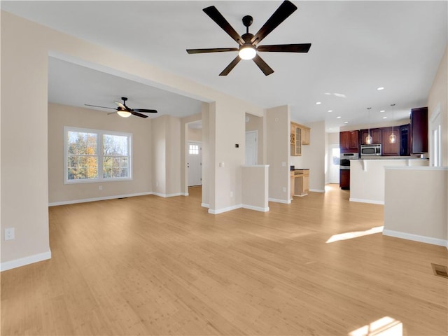 unfurnished living room with light hardwood / wood-style flooring and ceiling fan