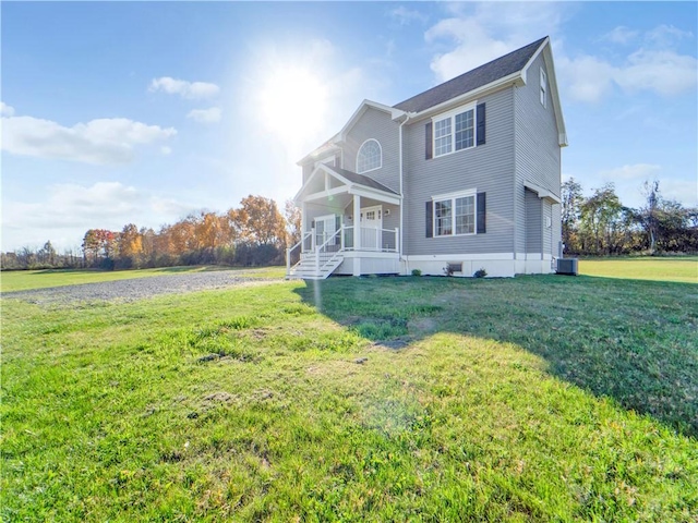 exterior space with a porch, central AC unit, and a front lawn