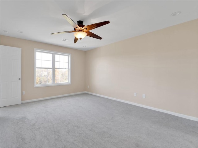 empty room featuring light carpet and ceiling fan