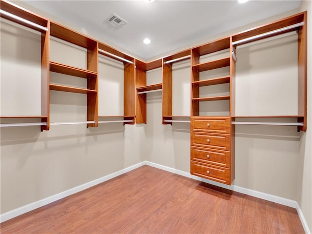 walk in closet featuring light hardwood / wood-style flooring