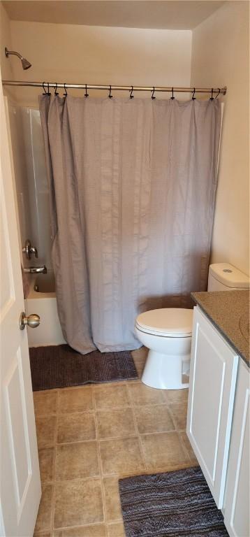 full bathroom featuring shower / tub combo, vanity, and toilet