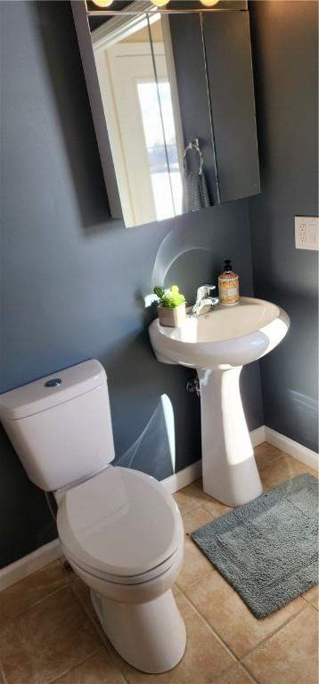 bathroom with tile patterned flooring and toilet