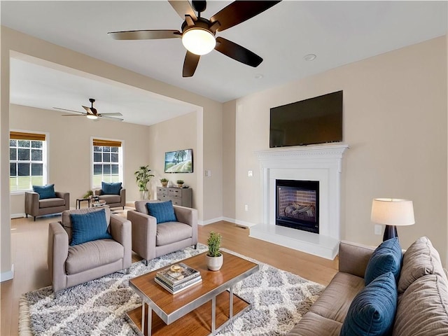 living room featuring wood-type flooring and ceiling fan