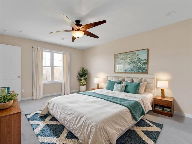 bedroom with light carpet and ceiling fan