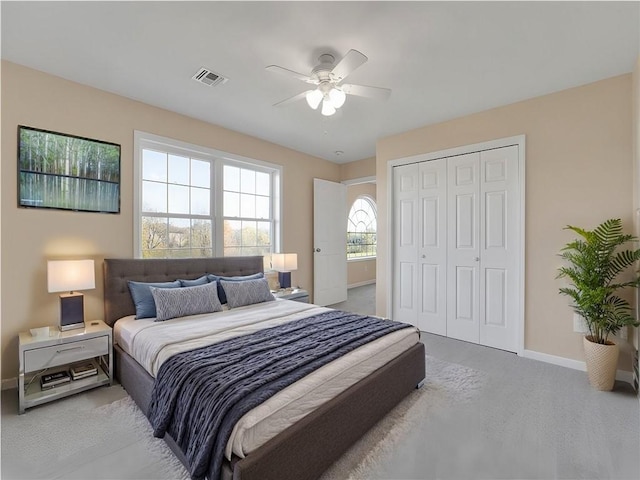 carpeted bedroom featuring a closet and ceiling fan