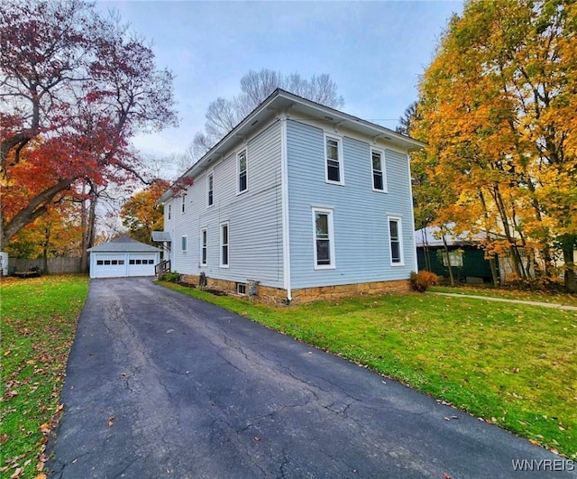 view of property exterior featuring an outbuilding, a yard, and a garage