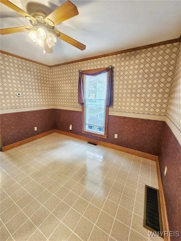 unfurnished room featuring crown molding and ceiling fan