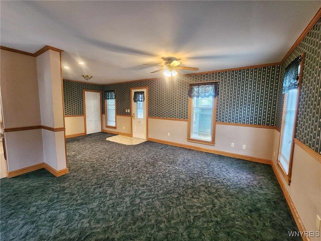 carpeted spare room with ornamental molding and ceiling fan