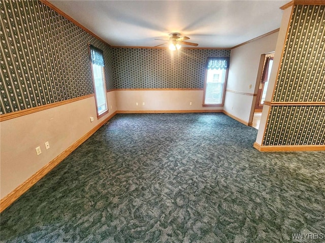 carpeted spare room featuring ornamental molding and ceiling fan