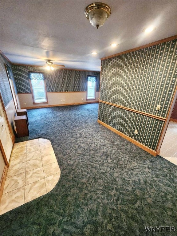 carpeted spare room featuring a textured ceiling and ceiling fan