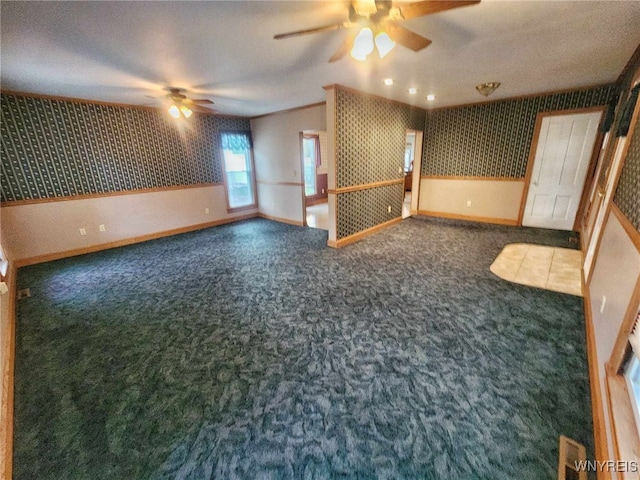 carpeted empty room with ceiling fan and a textured ceiling