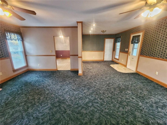 empty room featuring dark carpet and ceiling fan