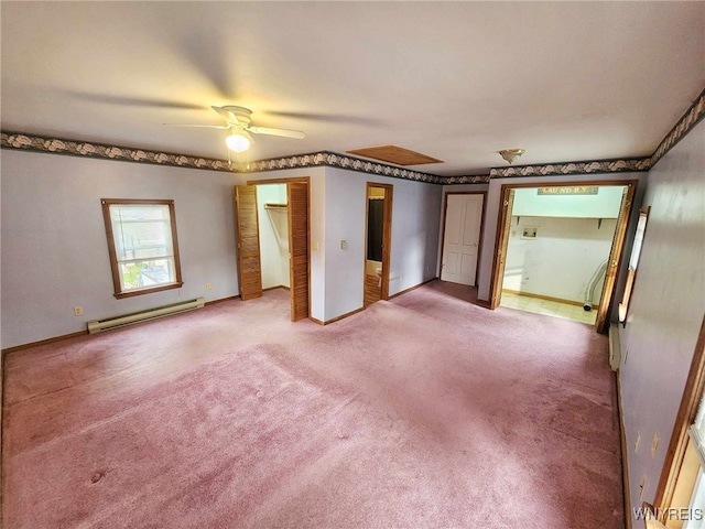 carpeted empty room with ceiling fan and a baseboard radiator