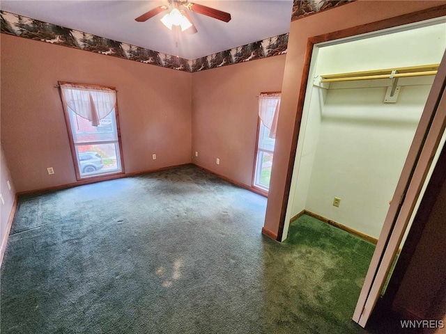 unfurnished bedroom with multiple windows, a closet, carpet flooring, and ceiling fan